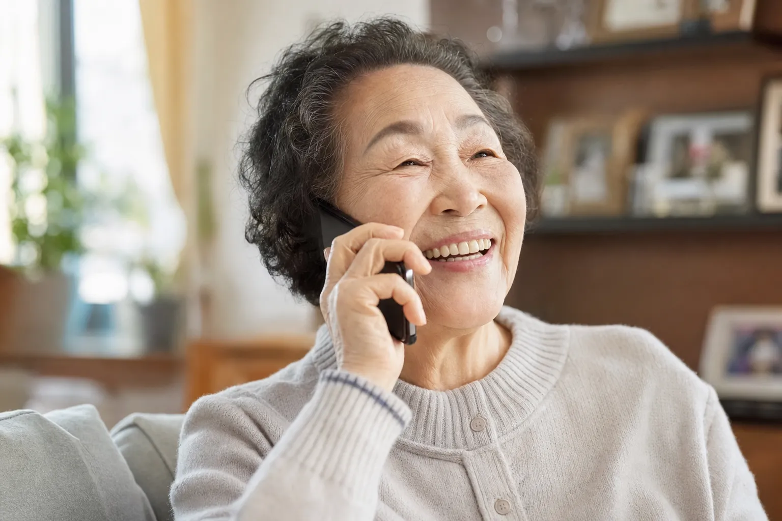 An elder smiling through a warm check-in call